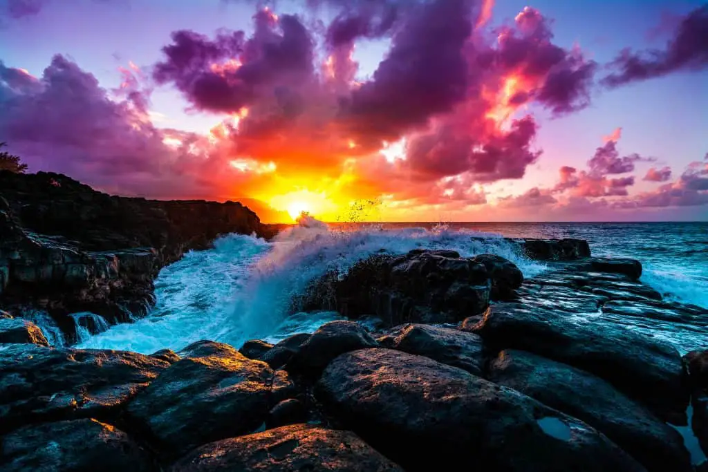 Beautiful scenery of rock formations by the sea at Queens Bath, Kauai, Hawaii at sunset