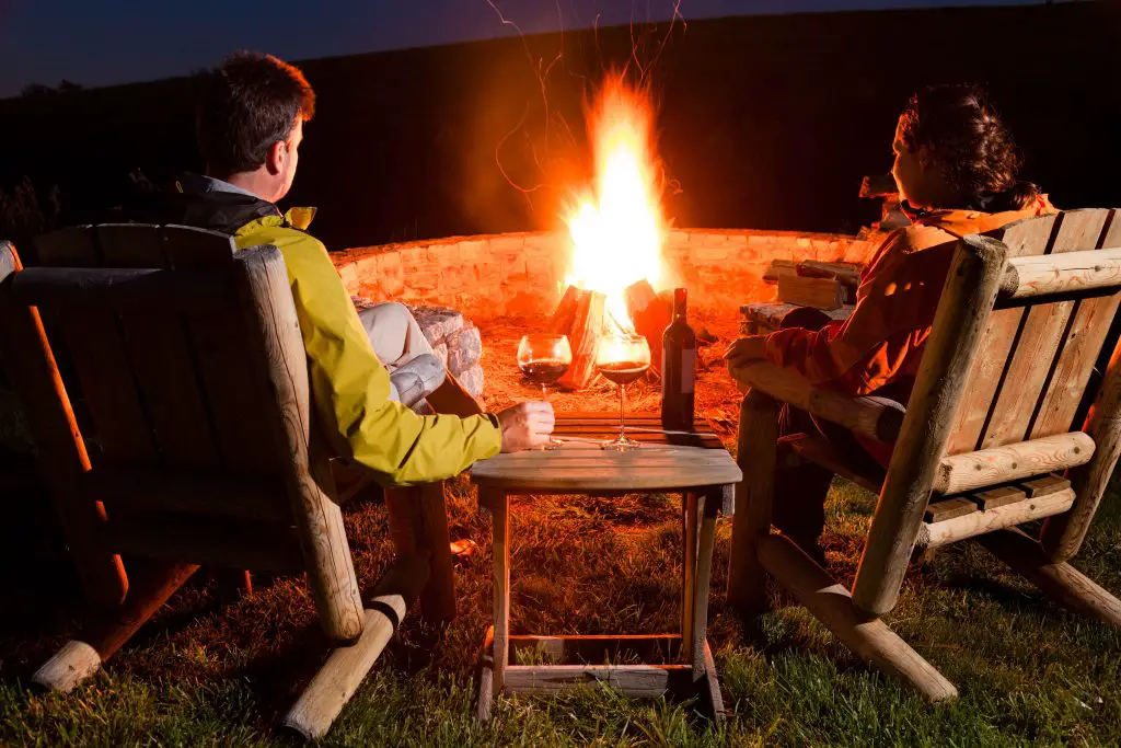 Couple Camping around a Bonfire - Bucket List Ideas