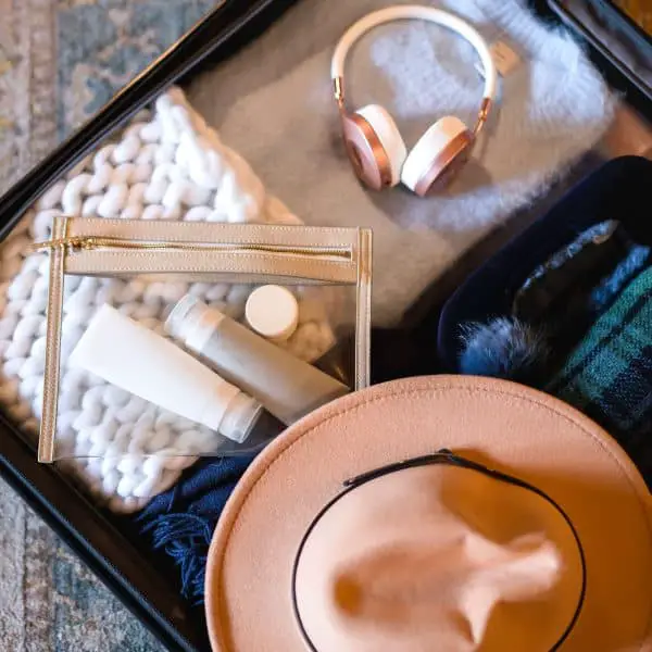 A travel suitcase packed with essential items for long flights.